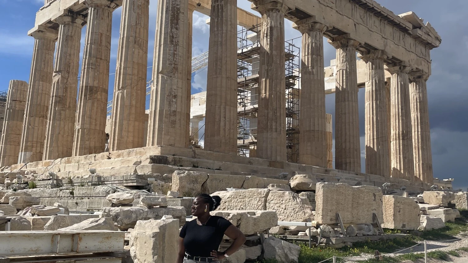 student in front of the Partenon in Athens, blue sky,